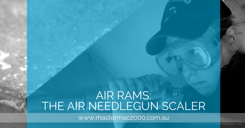 woman in protective goggles using a needlegun scaler